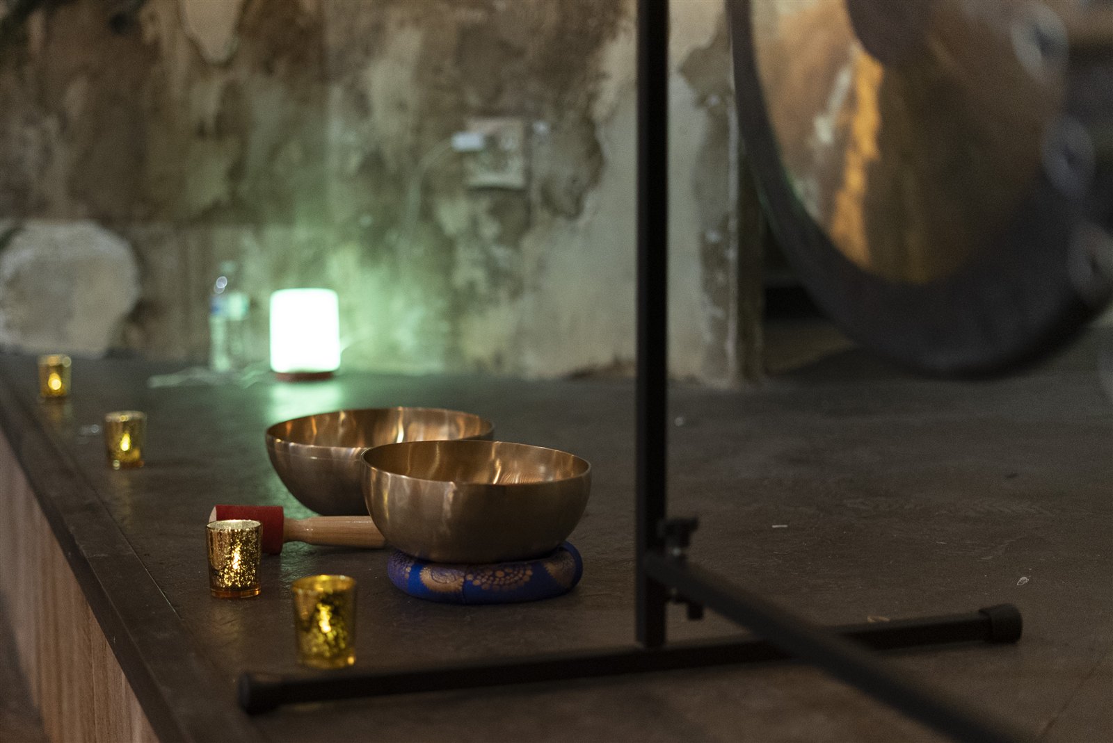 Singing bowls, candlelight, and a gong prepared for a restful session at Vineyard Vitality Escape.